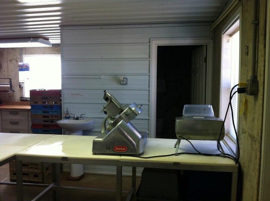 a room with counter space and meat processing equipment